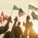 people_waving_international_flags_at_sunrise